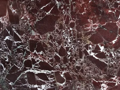 Red Levante natural stone slab — oxblood red with white breccia