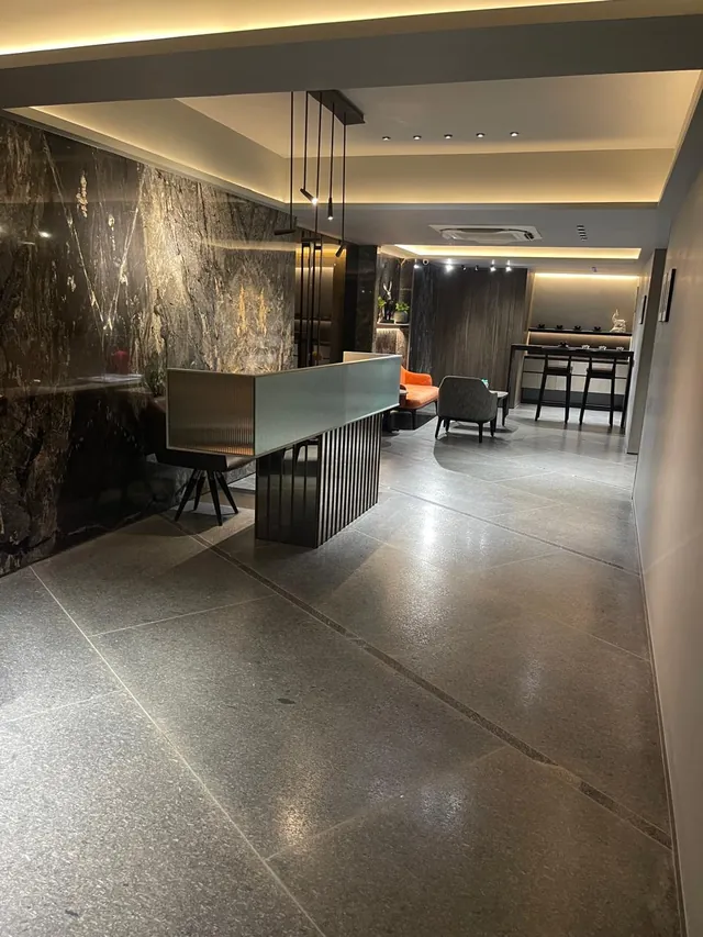 Lounge with a dark marble wall and polished stone floor