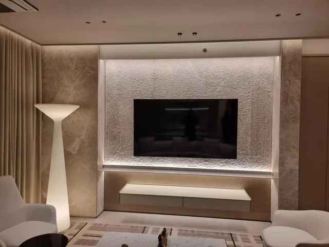 Living room with a light grey marble TV wall