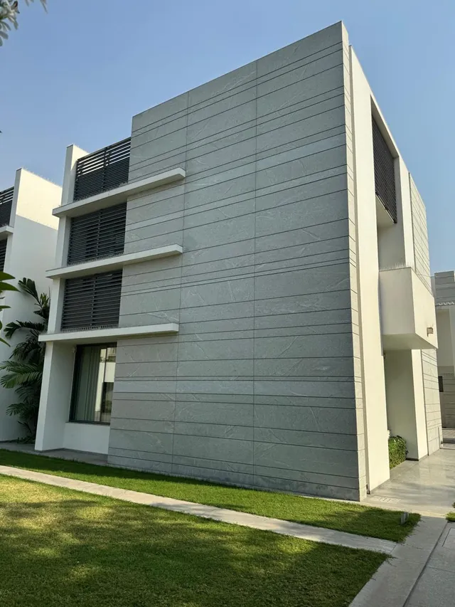 Grey stone-clad façade of a modern residence