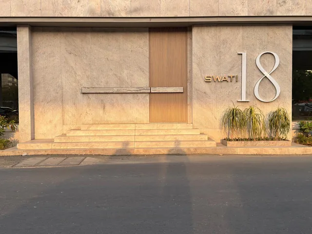 Stone-clad entrance façade at sunset
