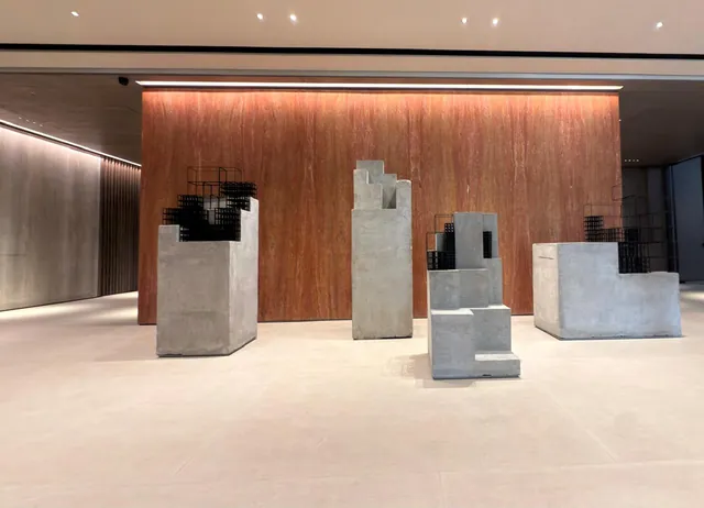 Office reception with a pale stone floor and timber wall