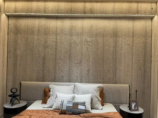Bedroom with a textured travertine feature wall